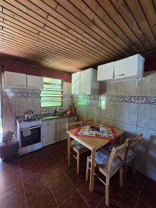 a kitchen with a table and chairs and a stove at Nido Rústico in Rivera