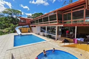 an image of a house with a swimming pool at Hotel Puerto San Luis in Tilarán