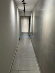 an empty hallway with a ceiling fan in a building at San Juliano Studios in Foz do Iguaçu +2 photos