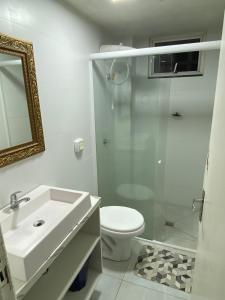 a bathroom with a sink and a toilet and a shower at San Juliano Studios in Foz do Iguaçu