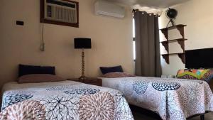 维多利亚城Residencia completa 2 recamaras para 4 con cochera的一间卧室，配有两张床和一扇窗户