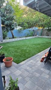 a patio with a yard with grass and trees at Cozy Tiny Home For 2 People Studio Type in Norwalk