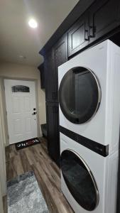 a microwave oven hanging on a wall in a kitchen at Cozy Tiny Home For 2 People Studio Type in Norwalk