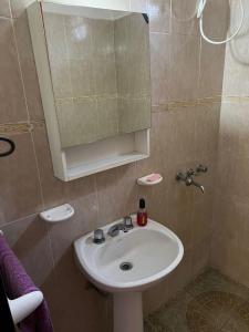 ein Badezimmer mit Waschbecken und Spiegel in der Unterkunft Único loft con pileta cerca de Villa Carlos Paz in San Antonio de Arredondo + 10 Fotos