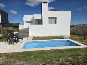 una villa con piscina di fronte a una casa di CountryHome Tierra Alta a Villa San Nicolás