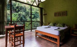 En eller flere senge i et værelse på Rio Claro Reserva Natural