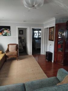 a living room with a couch and a chair at Holiday house in Nelson Bay