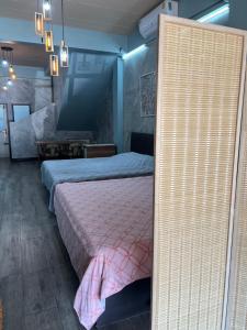 a bedroom with two beds and a pink bedspread at Sea Skyline family in Sattahip +8 photos