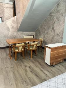 a dining room with a wooden table and chairs at Sea Skyline family in Sattahip