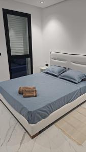 a bed with two pillows on top of it at loft in El Aouina Station