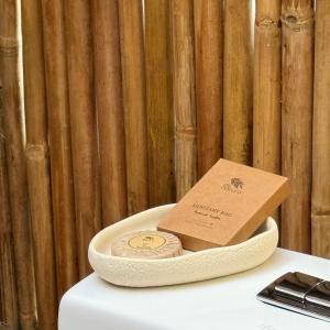 a box of coins in a bowl on a table at Cambaya Beach Resort in Busuanga
