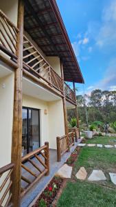 a house with a wooden railing and a yard at Pousada do Barão in Lindóia +14 photos