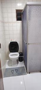 a small bathroom with a toilet and a shower at Casa do Fernando in São Gabriel