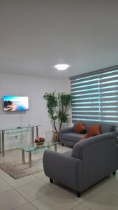 a living room with two couches and a table at Cielito Lindo in Uruapan del Progreso