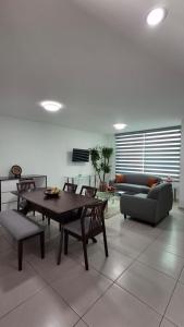 a living room with a table and a couch at Cielito Lindo in Uruapan del Progreso