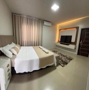 En eller flere senge i et værelse på Refúgio dos Sonhos Conforto e Tranquilidade + 17 billeder