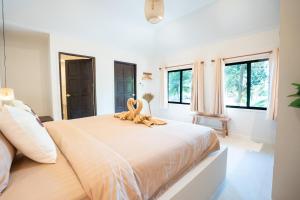 a bedroom with a large bed with two stuffed animals on it at Relax Bay Beach Resort in Ko Lanta +85 photos