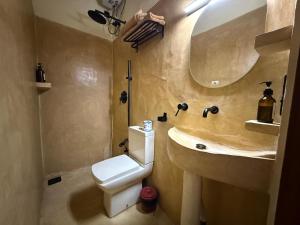 a bathroom with a sink and a toilet and a mirror at Tahini and Friends Surf, Yoga & Wellness in Ahangama +62 photos