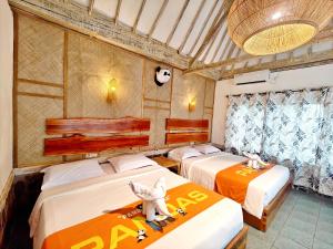 een slaapkamer met 2 bedden en een kamer met 2 bedden bij Panda Home in Gili Trawangan