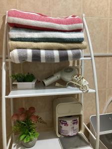 a towel rack with a phone and towels on it at Entire accommodation Departamento Mi Mexico in Mexico City
