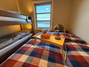 a bedroom with a bed with a table with pumpkins on it at Unique view! Modern apartment with sauna in Vossevangen