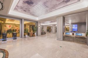 a large lobby with a ceiling with a chandelier at Mercure Beijing Future Science City in Beijing