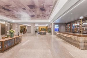 a large room with a library with a large ceiling at Mercure Beijing Future Science City in Beijing +118 photos
