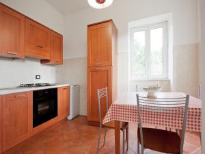 une cuisine avec des armoires en bois et une table avec une nappe rouge et blanche dans l'établissement Spacious home surrounded by nature, à Sesta Godano