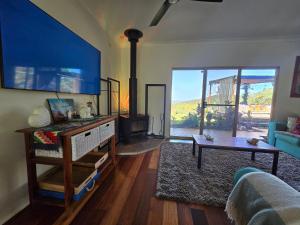 ein Wohnzimmer mit Sofa und Kamin in der Unterkunft Gold Coast Hinterland Experience No ppl 8 in Tallebudgera