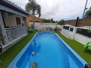 a swimming pool in the backyard of a house at Tortue marine in Saint-Benoît
