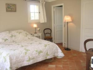 a bedroom with a bed and a window and a chair at Bastide Selva in La Garde-Freinet +44 photos
