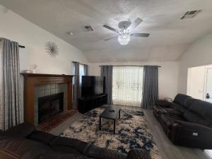 a living room with a couch and a fireplace at Emmanuel House in Tulsa