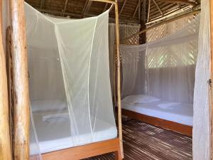 a bedroom with two beds in a tent at Backpacker's Hill Resort in San Vicente