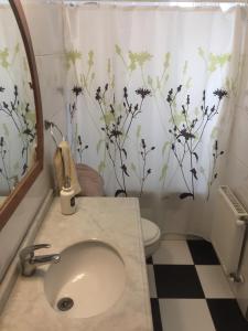 a bathroom with a sink and a toilet at Casona Valpo in Valparaíso