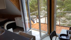 a room with a sliding glass door to a deck at Na Wydmach. Spokój. Cisza. Las dookoła in Hel