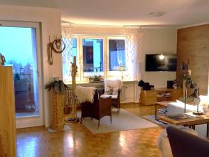 a living room with a couch and a table and chairs at Harz-Fewo-Wolf in Bad Harzburg