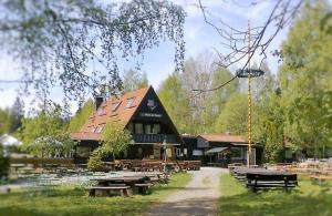a large building with picnic tables in front of it at Harz-Fewo-Wolf in Bad Harzburg