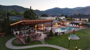 a view of a resort with a pool and tables and chairs at Mountain View Lodge in Chelan