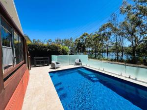 a swimming pool in the backyard of a house at Lakeview at Berringer in Manyana