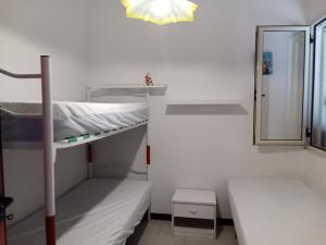 a small room with a bunk bed and a mirror at Appartamento Eucalpti Baia Verde By Nonsolomare Case Vacanze srlu in Baia Di Gallipoli