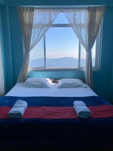 En eller flere senge i et værelse på Sadamo Homestay