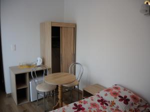 a room with a table and two chairs and a desk at AQUILA Pokoje Gościnne in Mielno
