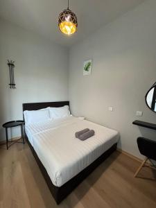 En eller flere senge i et værelse på Jesselton Quay by SNUG SPACE