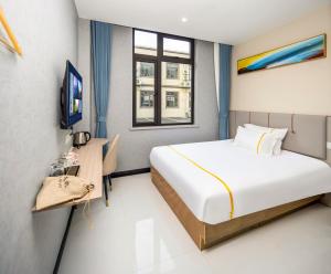 a bedroom with a large bed and a window at Shanghai Rui deng hao Hotel-Free shuttle bus to Airport and Disneyland 24x7 in Shanghai