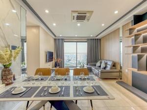 a dining room with a table with wine glasses at QMP - Vinhomes D'Capitale Tran Duy Hung in Hanoi