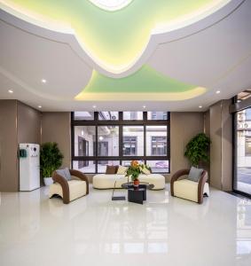 a lobby with couches and a table in a building at Shanghai Rui deng hao Hotel-Free shuttle bus to Airport and Disneyland 24x7 in Shanghai