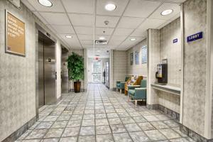 a hallway of a hospital with couches and chairs at Motel 6-London, ON - Ontario in London