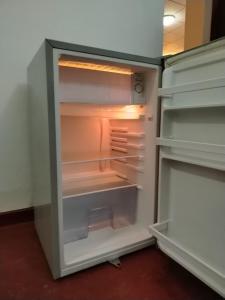 an empty refrigerator with its door open at Villa Green Garden in Hikkaduwa