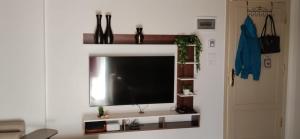 a flat screen tv sitting on a white wall at in luxor apartment in Luxor