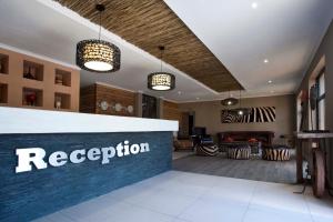 a reception area of a hotel with a reception counter at Daan Viljoen Game Lodge in Windhoek